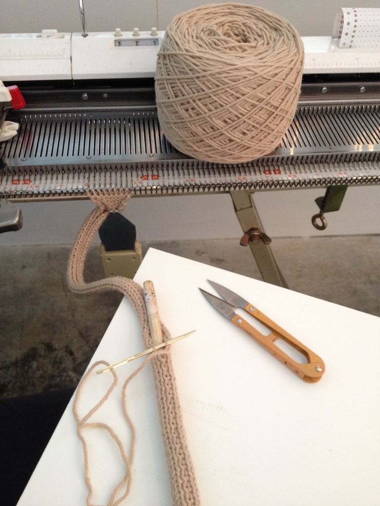 Machine knitting a wooden dowel